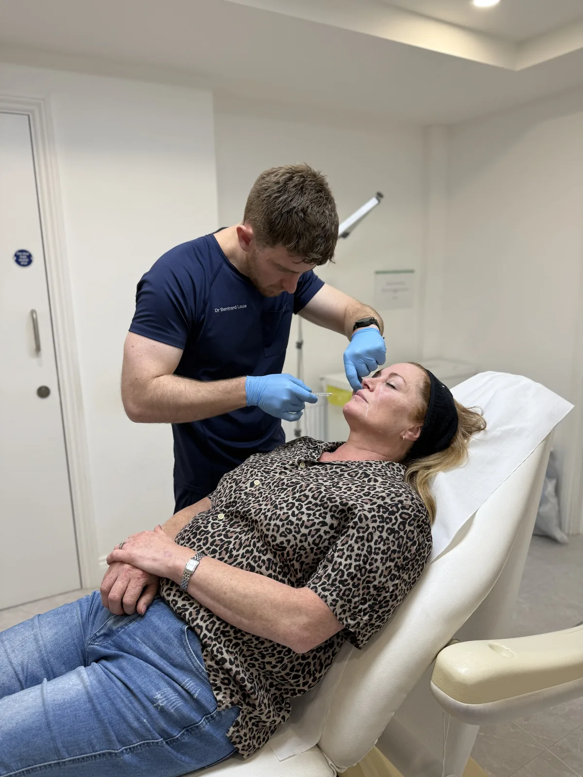 Dr. Bernhard Louw performing a facial rejuvenation treatment
